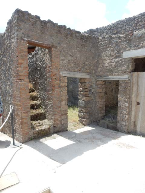 I.7.19 Pompeii. May 2017. Stairs to upper level on west side near entrance corridor and doorways to rooms in north-west corner of atrium. Photo courtesy of Buzz Ferebee.
