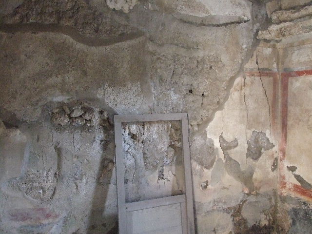 I.7.19 Pompeii. December 2006. South wall of cubiculum in south-west corner of atrium. The restored door of the sliding window from the west wall can be seen.

