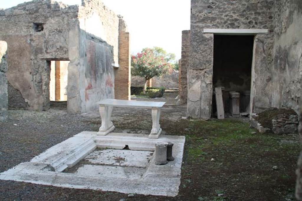I.8.5 Pompeii. October 2014. Looking across impluvium in atrium towards tablinum and garden area. Photo courtesy of Marie Schulze.
