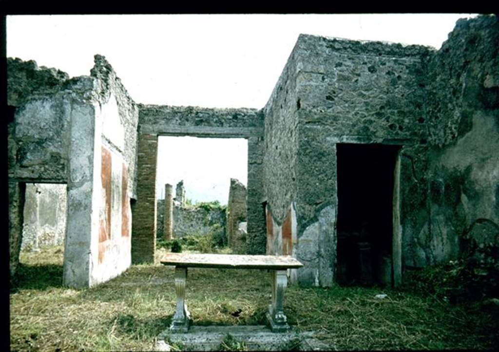 I.8.5 Pompeii. Looking south from impluvium towards tablinum and garden.
In the room with the doorway on the right, (south-west corner of atrium) a ship graffiti was seen on the white west wall of the cubiculum.  At the rear of the garden was the triclinium. Photographed 1970-79 by Günther Einhorn, picture courtesy of his son Ralf Einhorn.

