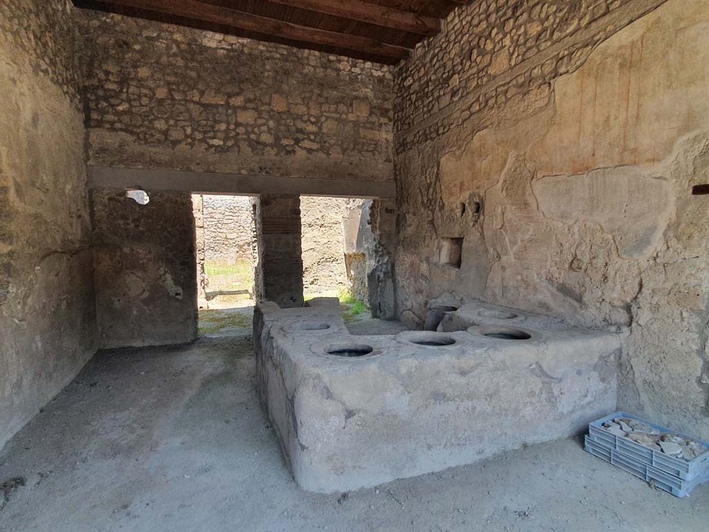 I.8.15 Pompeii. July 2021. Looking north-east across podium in shop-room, and two rear rooms on its north side.
Foto Annette Haug, ERC Grant 681269 DÉCOR.

