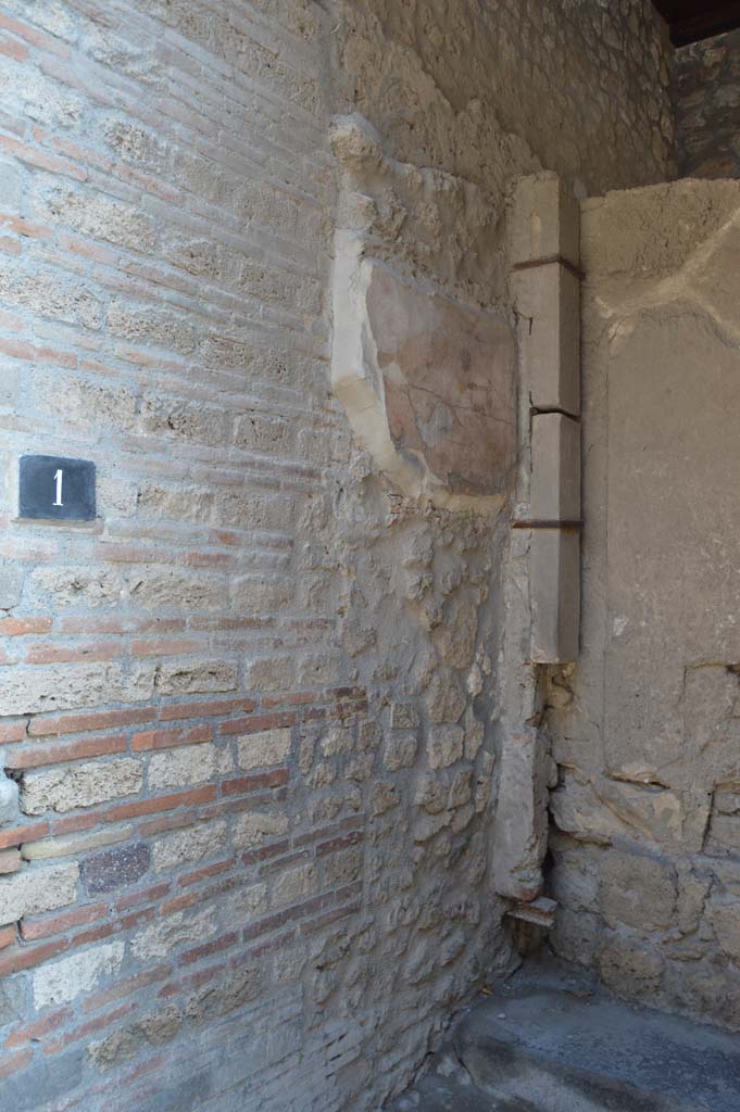 1.9.1 Pompeii. December 2018. East wall of vestibule, detail of remains of wall painting of Mercury. Photo courtesy of Aude Durand.