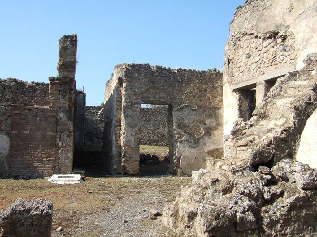 I.9.10 Pompeii. September 2005. Atrium, looking west from entrance. In the north-west corner can be seen the doorways to three rooms.
