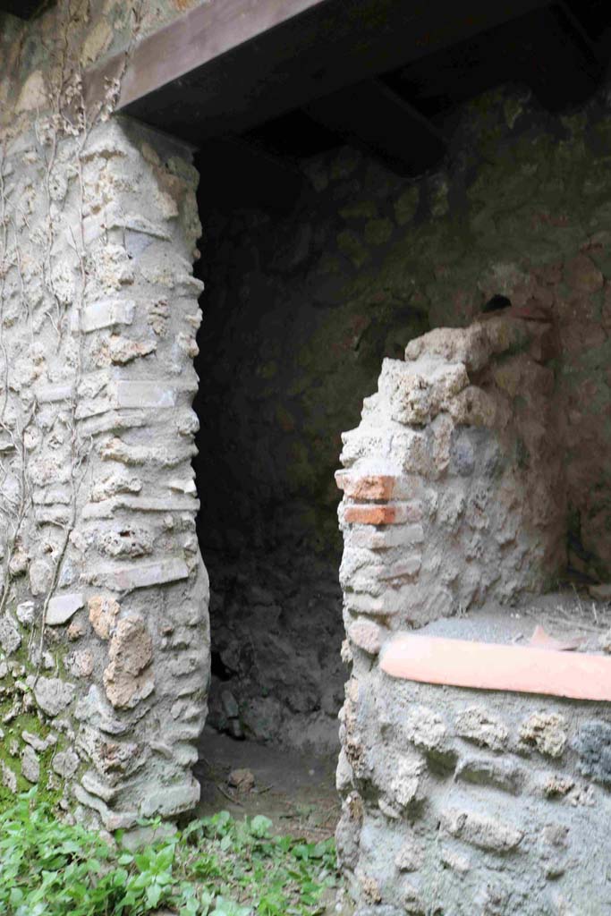 I.10.1 Pompeii. December 2018. 
Looking through doorway towards west wall of latrine area, with niche. Photo courtesy of Aude Durand.
