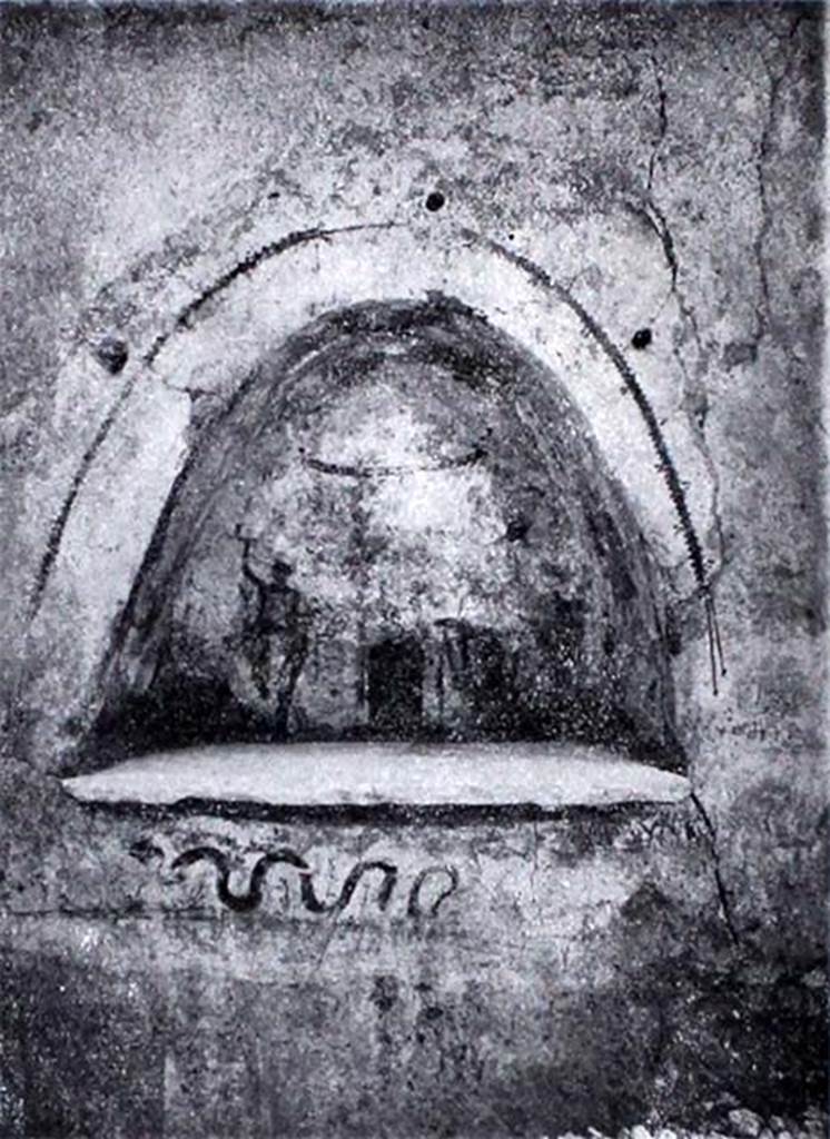 I.10.3 Pompeii. 1934. Niche on east wall of fauces. 
On the back wall is a painted round altar around which a small snake winds.
The altar is flanked by two pines and two Lares.
Above is a garland and below it in red was an inscription “Felix aeris IV as, Florus X.”. 
Below the niche a small snake moves to the left. 
See Notizie degli Scavi di Antichità, 1934, p. 272, fig. 5.
See Fröhlich, T., 1991, Lararien und Fassadenbilder in den Vesuvstädten. Mainz: von Zabern.  (L13 p. 255).  

