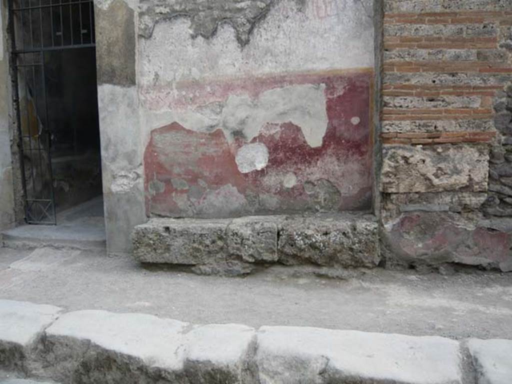 I.10.4 Pompeii. May 2012. Painted plaster on front wall to right of entrance, and faded graffiti. Photo courtesy of Buzz Ferebee.
