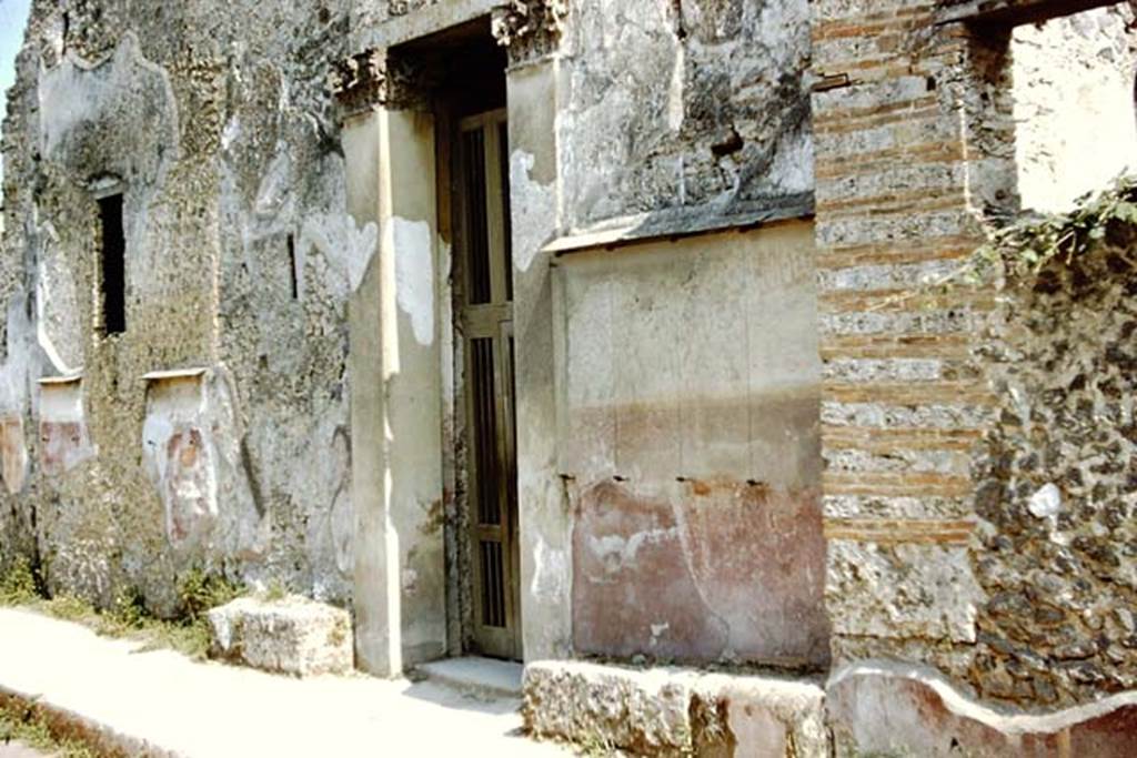 I.10.4 Pompeii. December 2005. Painted plaster on front wall to right of entrance, and faded graffiti.