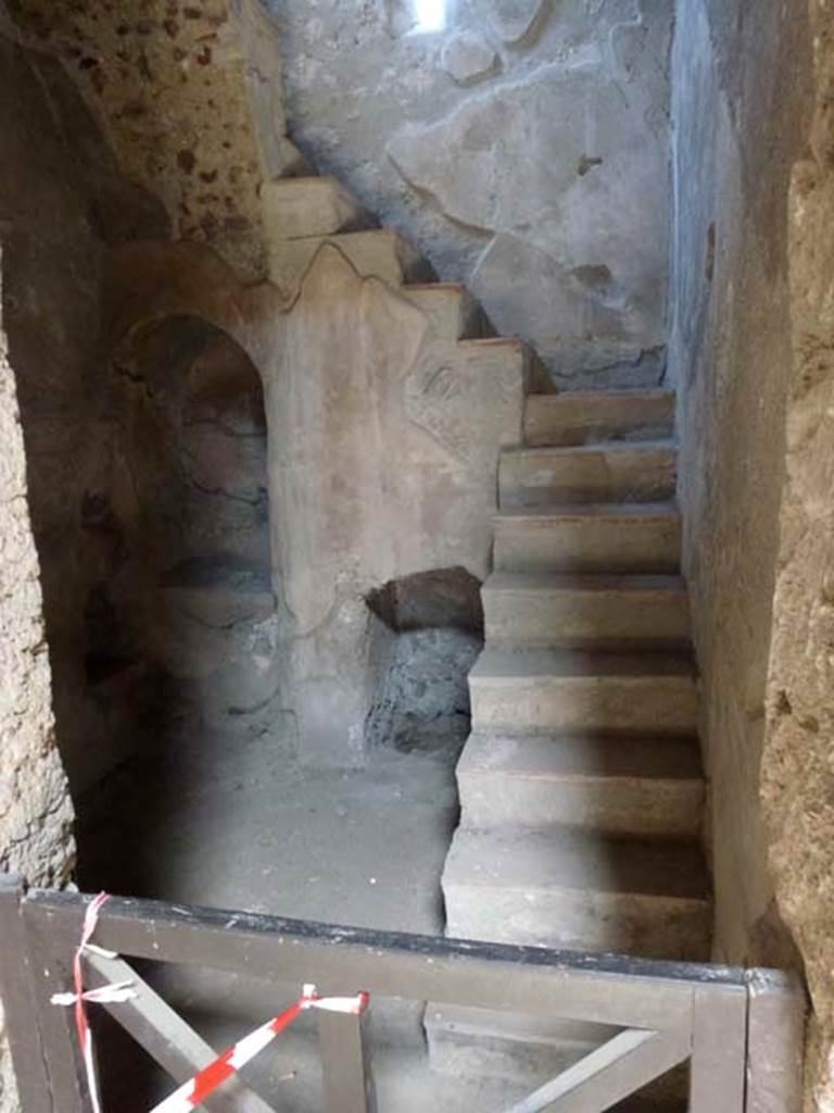 I.10.4 Pompeii. June 2012. Room 2, niche and recess below stairs to upper floor. According to Boyce, in a small room with an arched recess beneath the stairs, there was a small masonry altar with two cavities in the top, and a niche in the wall above. See Boyce G. K., 1937. Corpus of the Lararia of Pompeii. Rome: MAAR 14. (50C on p.28). He quoted his reference as MAIURI, Casa del Menandro, 37.  Photo courtesy of Michael Binns.
