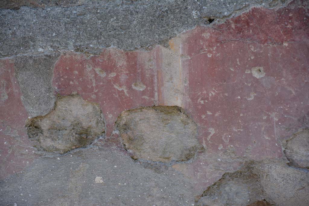 I.10.5 Pompeii. April 2017. Detail of painted plaster on east side of entrance doorway. Photo courtesy Adrian Hielscher.