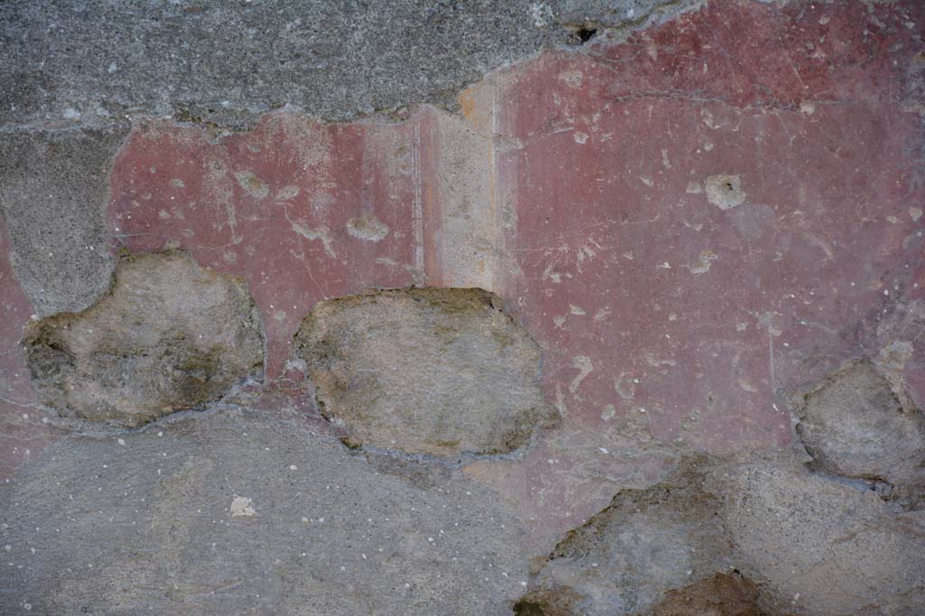 I.10.5 Pompeii. April 2017. Detail of painted plaster on exterior front façade on east side of entrance doorway. 
Photo courtesy Adrian Hielscher.
