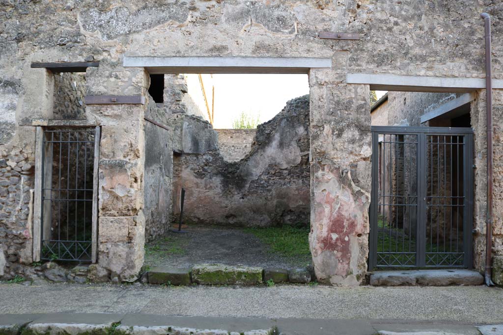 I.10.7 Pompeii, on right. December 2018. Looking south to doorways on Vicolo del Menandro. Photo courtesy of Aude Durand.