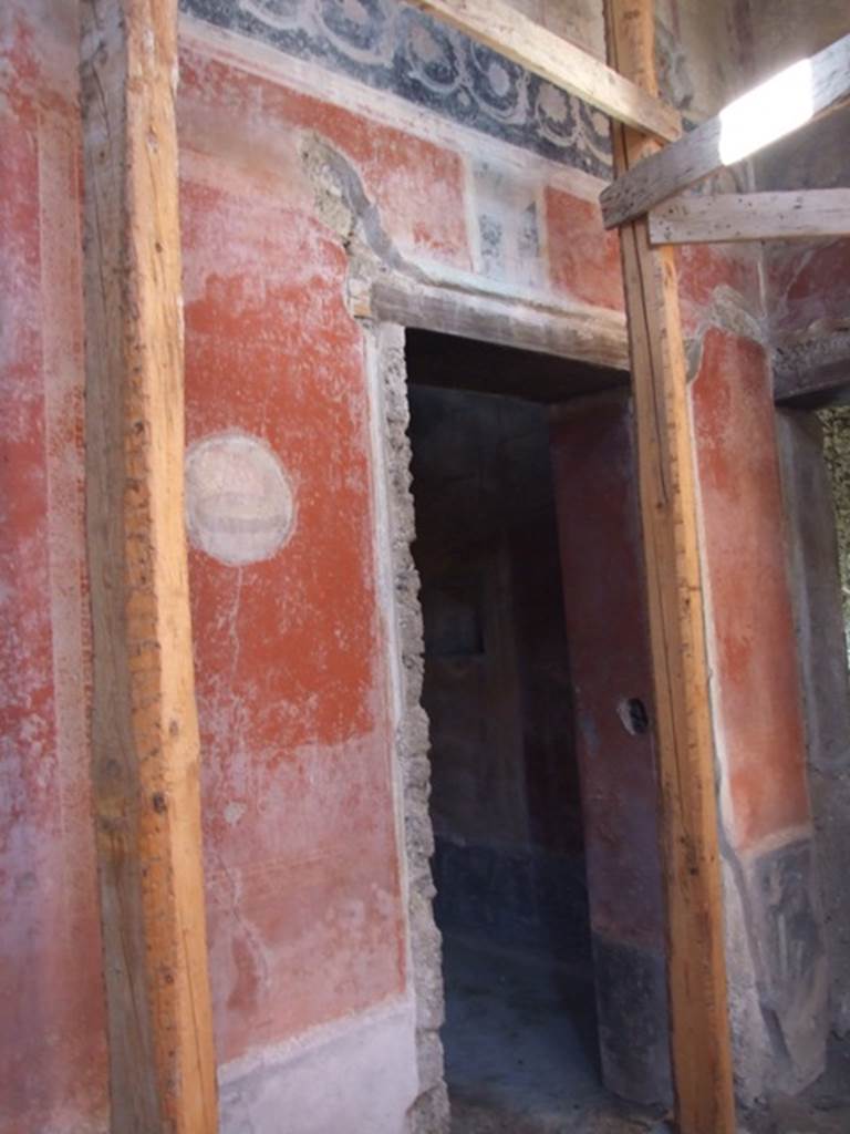 I.10.11 Pompeii. March 2009. Room 2, north-west corner of atrium.    
Doorway to room 9 in west wall, with painted medallion on wall to south.

