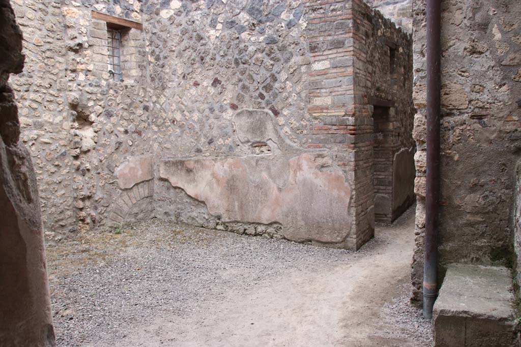 I.10.16 Pompeii. September 2021. 
Looking through doorway in south wall of atrium, leading into room with corridor and to I.10.15. Photo courtesy of Klaus Heese.
