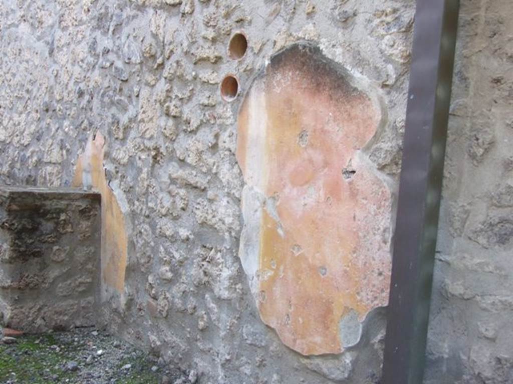 I.11.2 Pompeii. December 2007. Remains of painted plaster on west wall.  