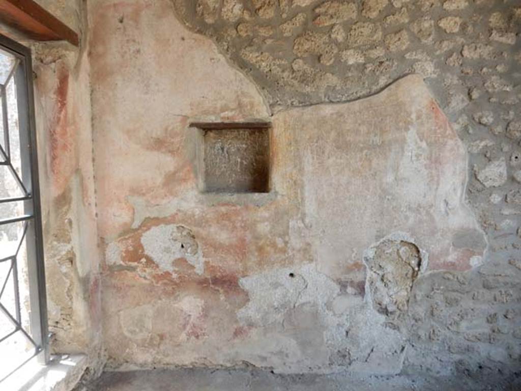 I.11.7 Pompeii. May 2015. West wall of the shop with niche and doorway to I.11.6 in south wall.
Photo courtesy of Buzz Ferebee.

