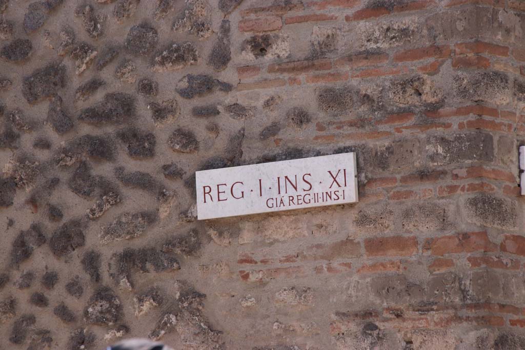 I.11.7 Pompeii, west side wall in Vicolo della Nave Europa. September 2019.  
Insula identification plaque, Reg. I. Ins. X1, previously known as Reg. II, Ins. 1. Photo courtesy of Klaus Heese.
