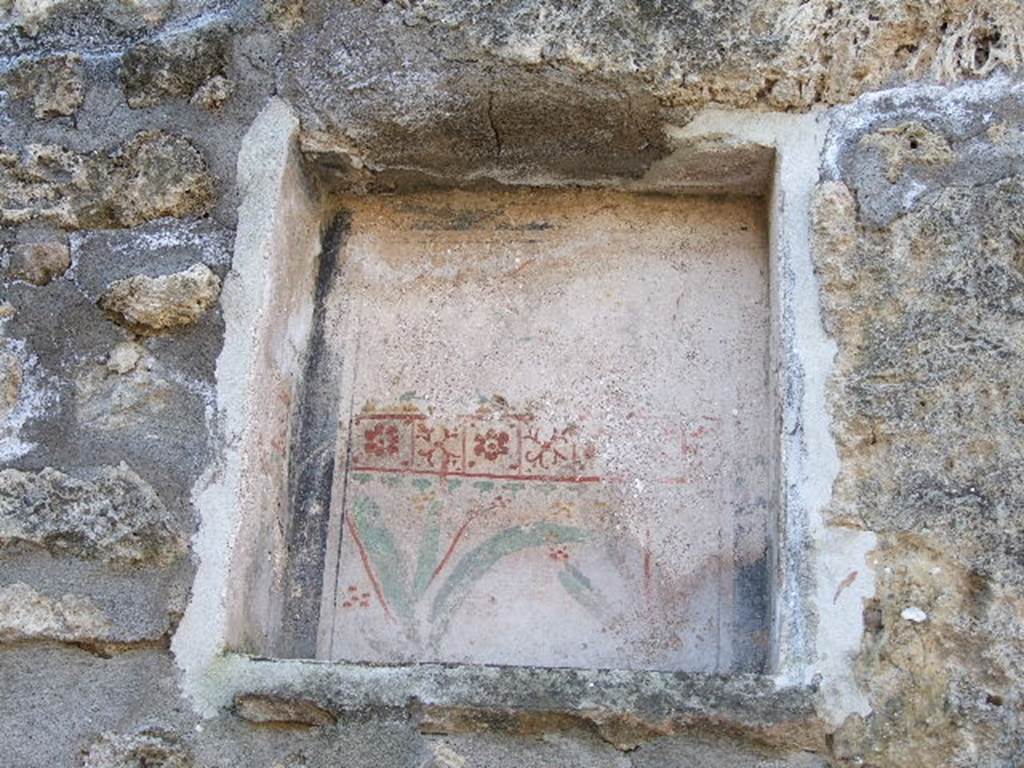 I.11.8 Painted niche on west wall of atrium.