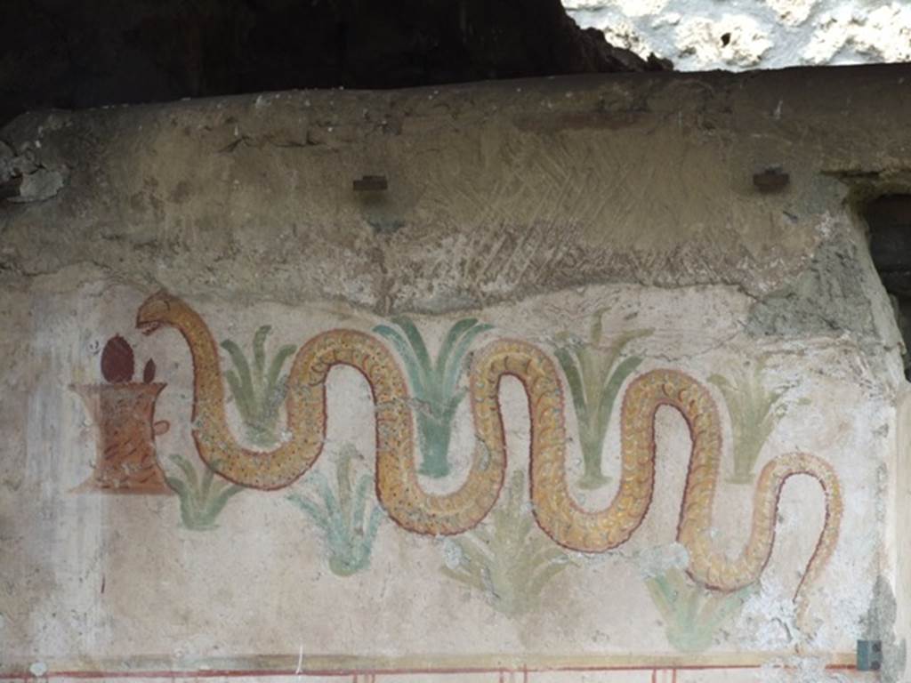 I.11.11 Pompeii. March 2009. Lararium. A serpent approaching a round altar from the left, passing through perennial plants.
