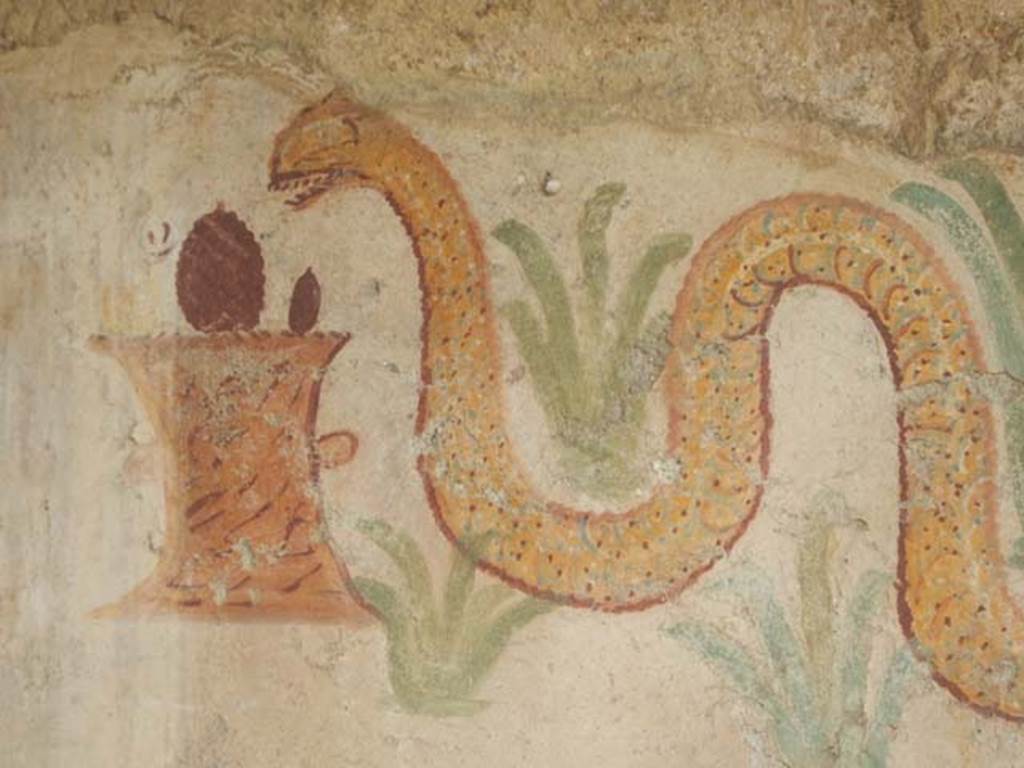 I.11.11 Pompeii. May 2017. Detail from painted lararium showing round altar and serpent in painted plants. Photo courtesy of Buzz Ferebee.
