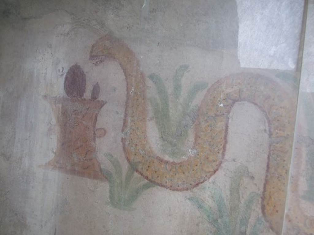 I.11.11 Pompeii.  May 2006. Lararium.  Detail of snake and altar.