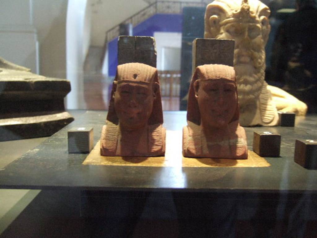 Two Egyptian style herm found in I.11.13.  Now in Naples Archaeological Museum.