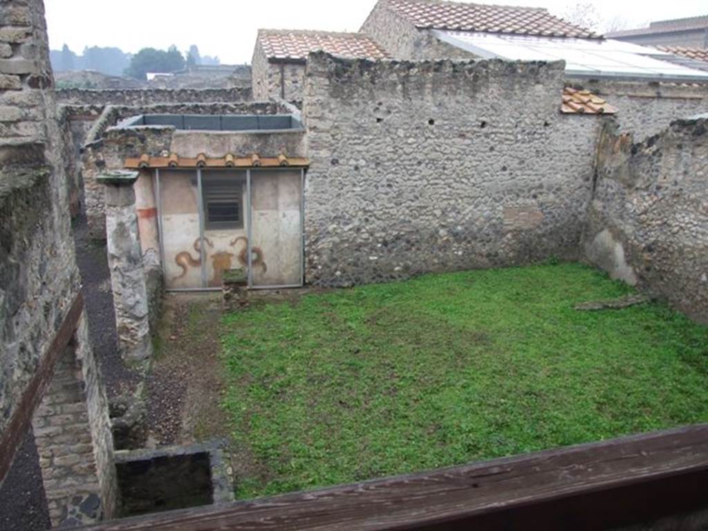 I.11.15 Pompeii. December 2007.  Looking west from upper floor overlooking garden peristyle area and household shrine.
