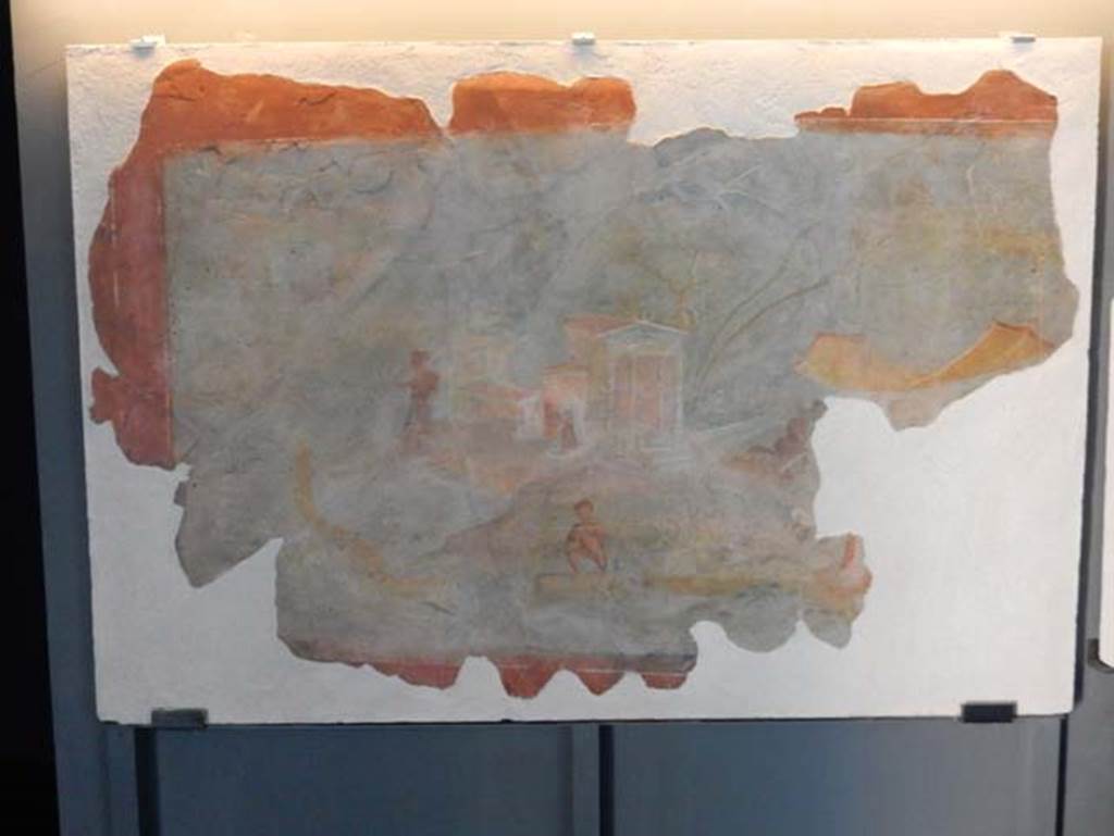 I.11.15, Pompeii. May 2016. Fragment of Nilotic scene. Photo courtesy of Buzz Ferebee.
The display card states that both fragments were once part of a single large fresco.
According to Grete Stefani, the painting (SAP 56310) is very interesting and has only recently been made known to scholars.
Detached from a wall of Pompeii in an unspecified period, it was preserved, without any indication of its provenance, in the Pompeii Excavations' Restoration Workshop and, despite the efforts made, it had so far not been able to trace the original location of the painting. 
New data presented here, on the other hand, may help to clarify, in addition to the provenance, some iconographic aspects.
In fact, the photographic documentation of 1953 relating to the painting is preserved at the Photographic Archive of the Superintendence when it was still on site on the external side of the opus craticium wall that delimited the balcony on the upper floor of the house of Pompeii I 11, 15 (Photo SAP A 1522, Fig. 4); the painting also included a portion with hippos, now restored as a panel in its own right and whose relevance had been lost (SAP LR16), and a contiguous portion, now lost.
See Stefani, G. 2010. Luoghi e Personificazioni di luoghi nelle Pitture dell'area Vesuviana: AIPMA 2010, p. 258, fig. 4.
(Our thanks to Domenico Esposito for his help in verifying the provenance of these fragments.)
