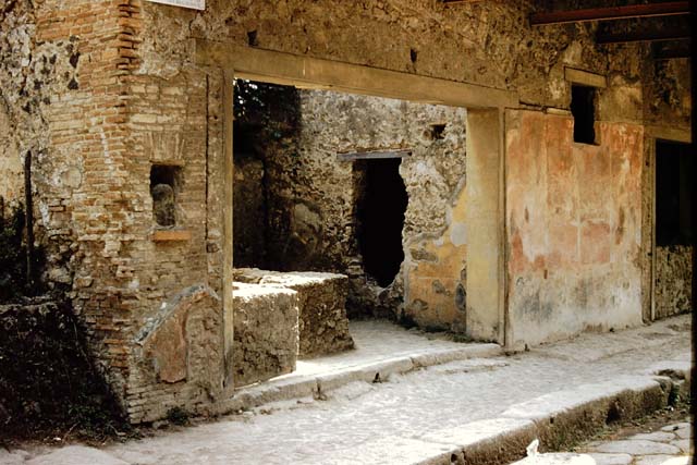 I.12.5 Pompeii, on left. December 2018. 
Looking south towards wall between two doorways with 1.12.4 on right. Photo courtesy of Aude Durand.
