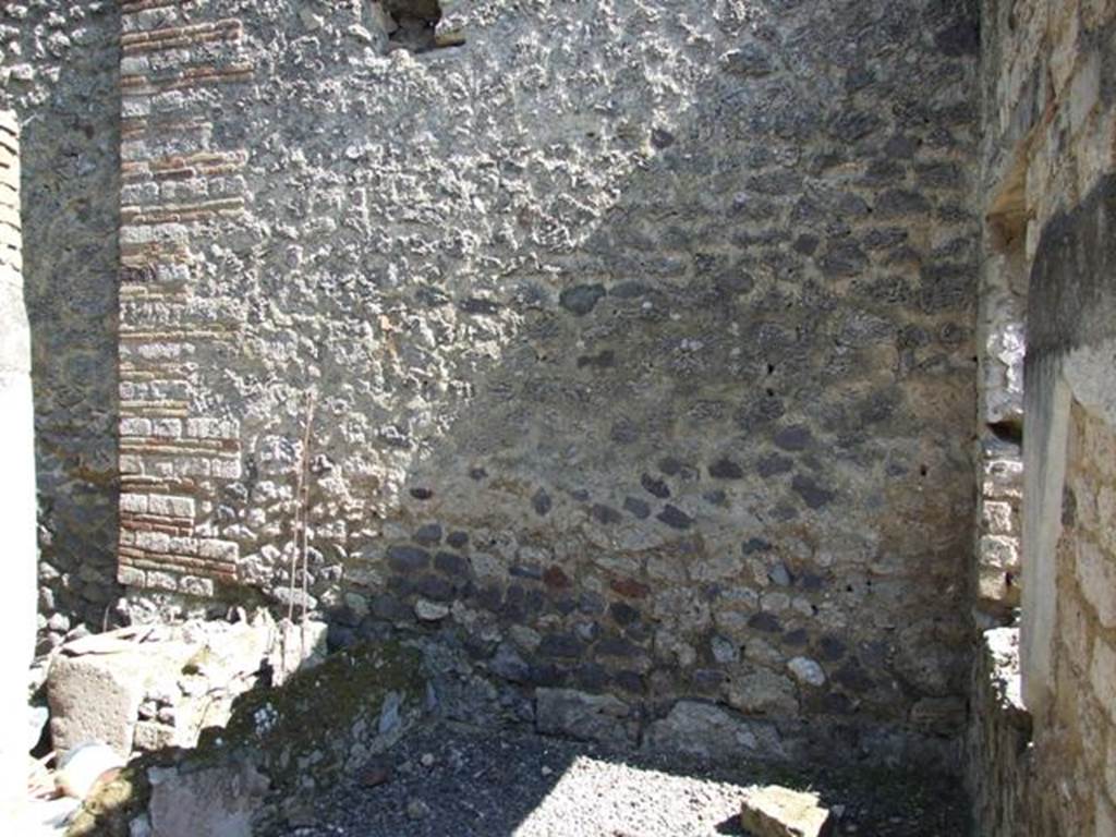 I.12.8 Pompeii. March 2009. East wall of south portico. On the left can be seen the remains of a shallow basin.