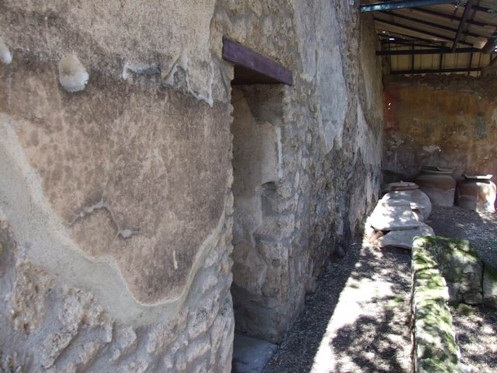 I.12.8 Pompeii. March 2009. Room 11, north wall of cubiculum. According to Curtis, on Eschebach’s 1969 plan of the house a doorway is shown from this cubiculum into the house at I.12.14.  This is an error. See Curtis R.L: The Garum shop of Pompeii, In Cronache Pompeiane, V.1979, p.8, note 5.  He also described this room as having a beautiful third style wall painting on three of its walls. The bordering appeared in deep green and the architectural structure above the panels contained differently shaped amphorae.
A large panel on each of the three walls contained a simple idyllic scene on a white background. See Curtis R.L: The Garum shop of Pompeii, In Cronache Pompeiane, V.1979, (p.20).

