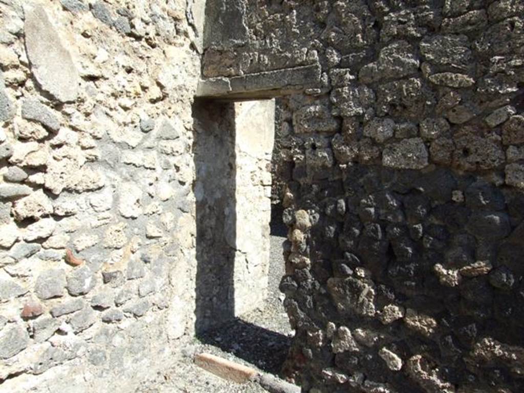 I.12.8 Pompeii. March 2009. East wall of room 5, with small doorway into room 7.
This doorway is not shown on the Eschebach 1969 plan.
