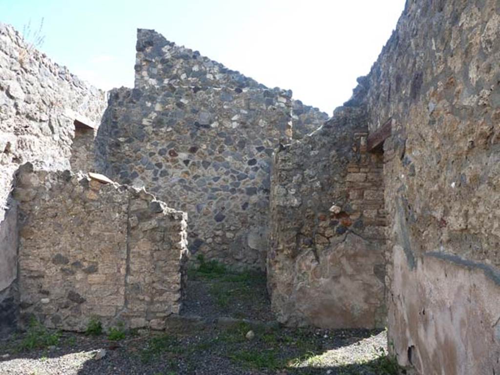 I.13.5 Pompeii. September 2015. South wall with doorway to rear room, centre, and doorway leading to I.13.4, on right.