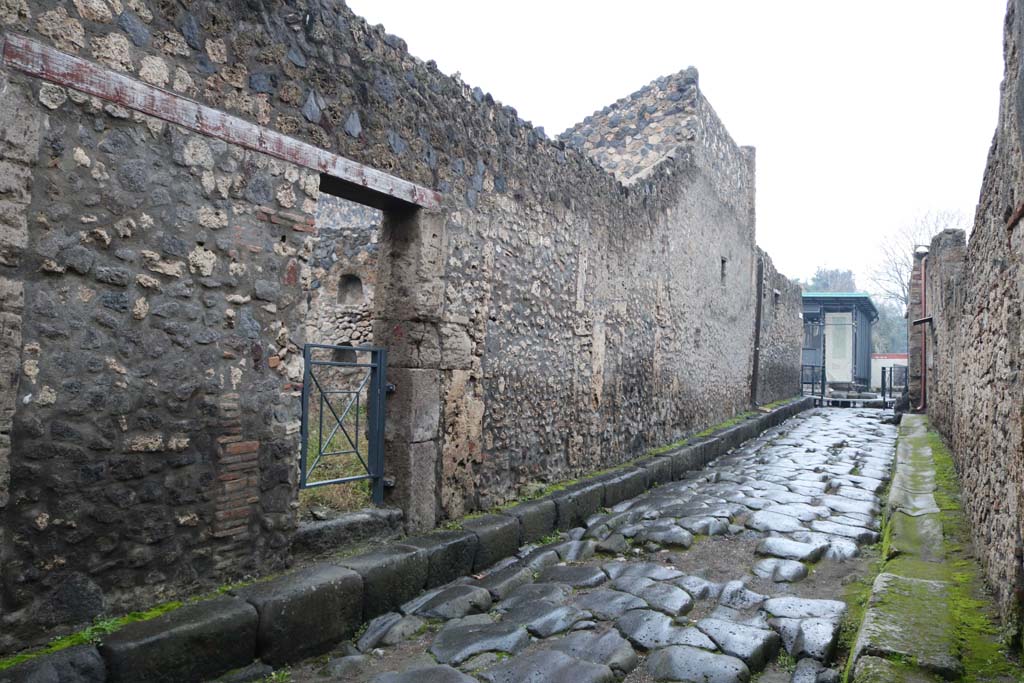I.13.6 Pompeii, on left. December 2018. Looking north on Via di Niocera between I.13 and II.1. Photo courtesy of Aude Durand.