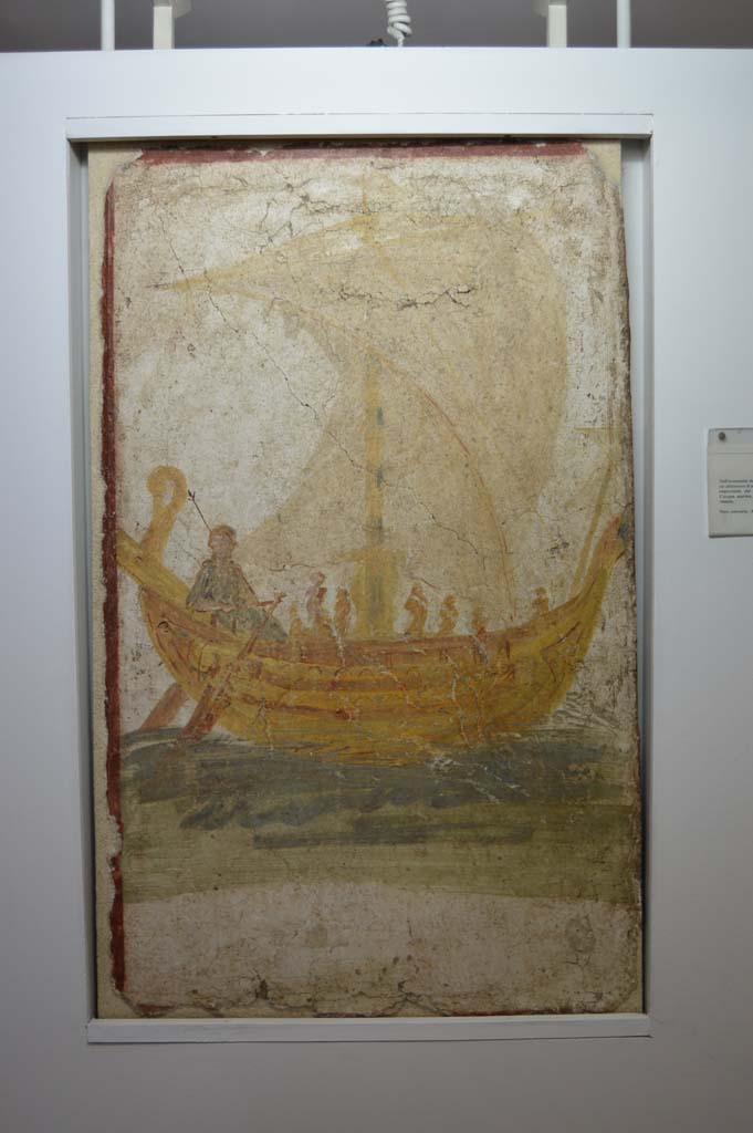 I.13.9 Pompeii. Venus on a boat, wall painting from exterior wall on south side of the entrance.   Photograph taken December 2006, Boscoreale Antiquarium. 
According to Varone, underneath the painting of a boat with open sails and Venus at the rudder acting a helmsman for the sailors, was a Greek inscription painted in black letters, saying “Venus the Saviour”. This was CIL IV 9867 but is no longer conserved.  See Varone, A., 2002. Erotica Pompeiana: Love Inscriptions on the Walls of Pompeii, Rome: L’erma di Bretschneider. (p.24)
According to Varone and Stefani, the inventory number of the painting should be 20697.  See Varone, A. and Stefani, G., 2009. Titulorum Pictorum Pompeianorum, Rome: L’erma di Bretschneider, (p.158)   According to Frohlich, the SAP inventory number was 2212-4.  See Fröhlich, T., 1991. Lararien und Fassadenbilder in den Vesuvstädten. Mainz: von Zabern. (p.311, F.13, taf 17,10)


