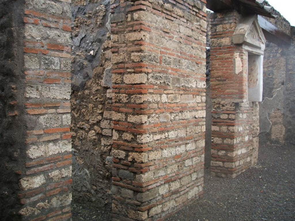 I.13.12 Pompeii. December 2004. West side of atrium, with doorway to steps to upper floor, doorway to Cubiculum, Isis Sacellum, and Ala.