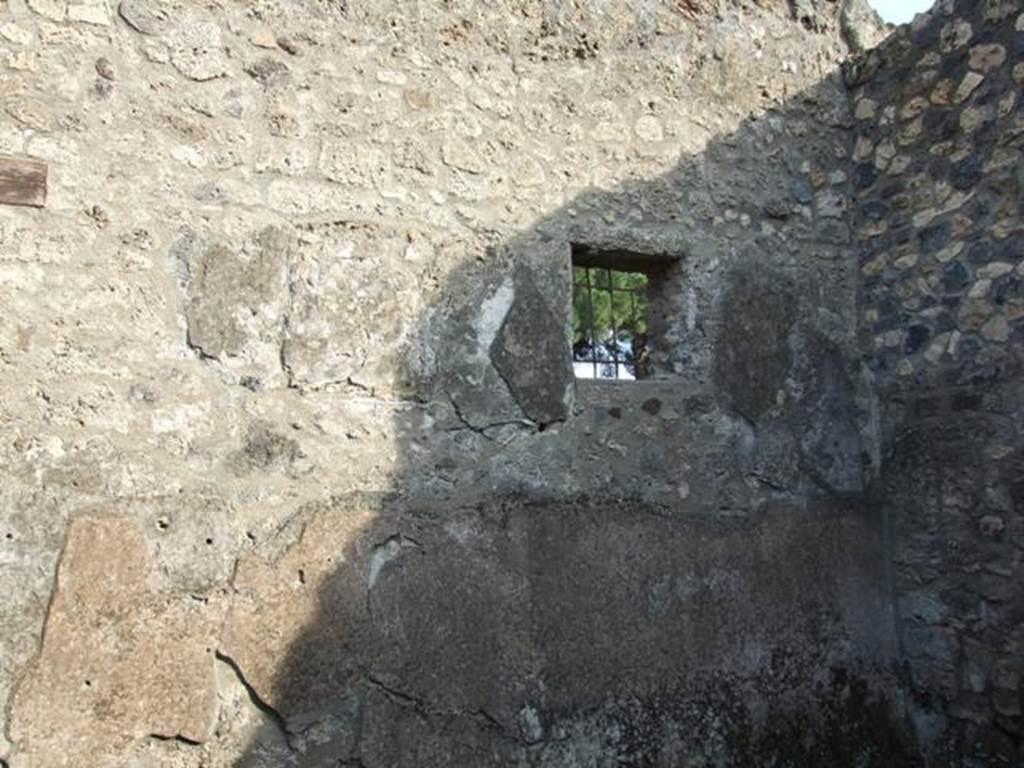 I.14.4 Pompeii. December 2007. Room 10, room to south of fauces. East wall with window with metal grille.