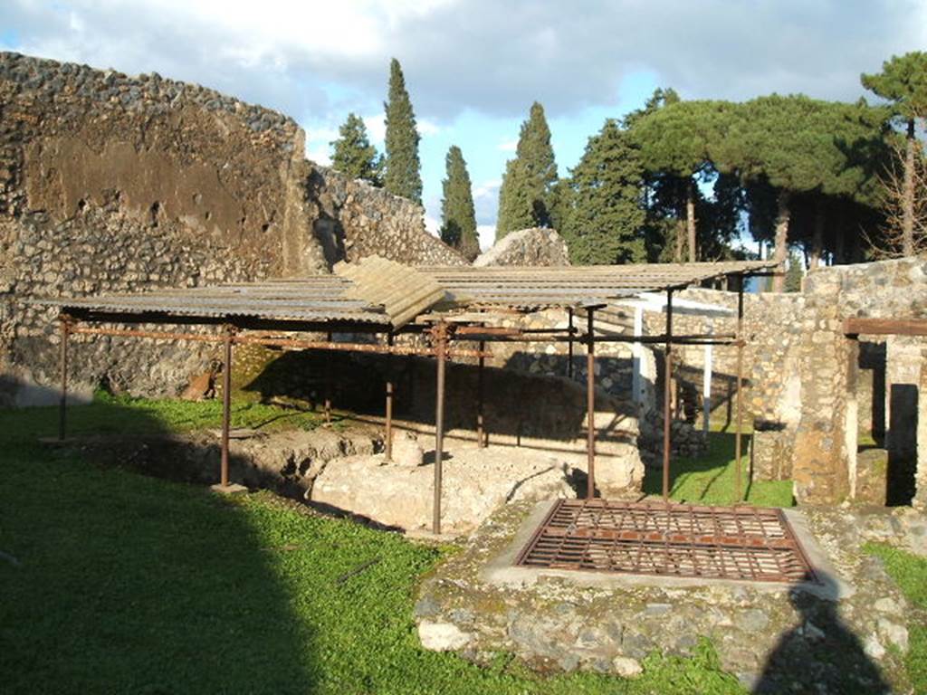 I.14.10 Pompeii. December 2004. Inspection shaft of Sarno Canal in front of the triclinium.