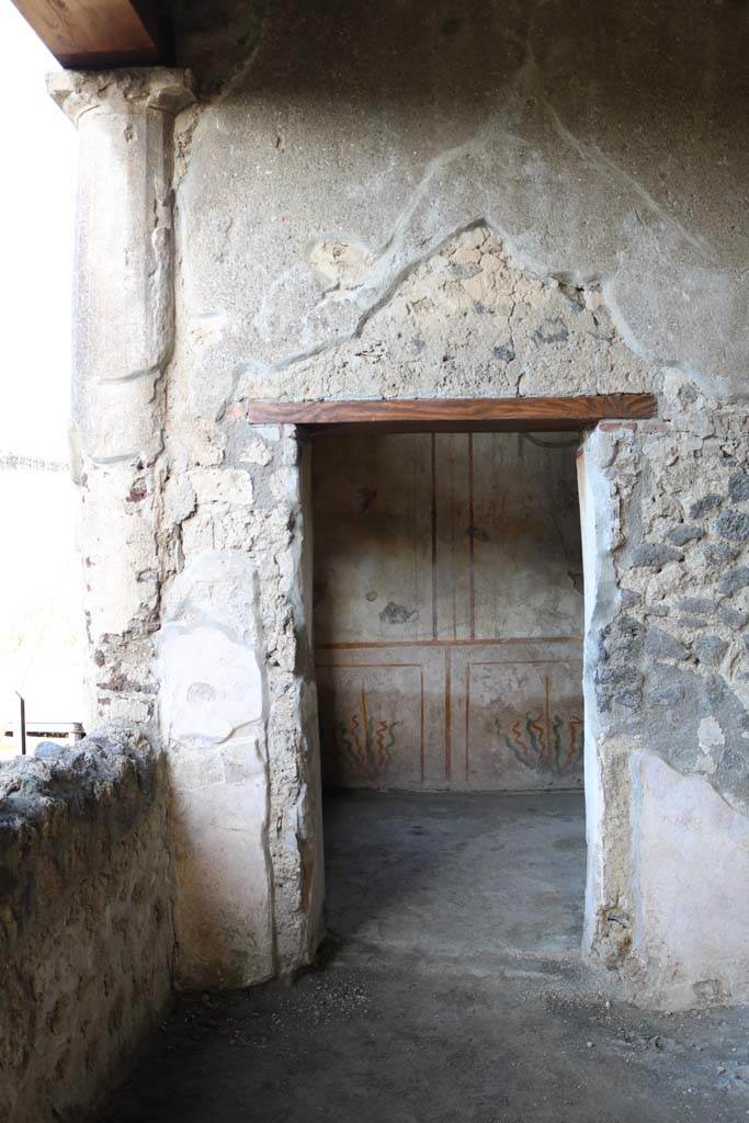 .14.12 Pompeii. December 2018. 
Doorway to room 2 on east side of peristyle, and north end of room 32, east portico, taken from I.14.13. 
Photo courtesy of Aude Durand.

