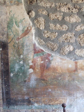I.16.5 Pompeii. September 2005. Remains of central painting on painted wall in room on east side of peristyle.