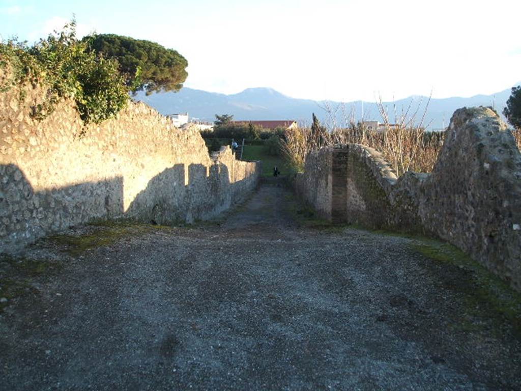 I.22 Pompeii. May 2010. Looking north along Vicolo delle Nave Europa between I.22 and I.21.