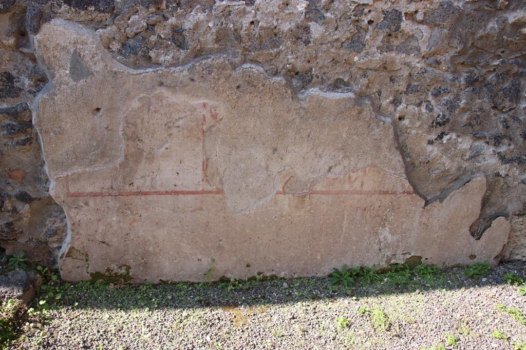 I.21.5 Pompeii. October 2022. Detail of painted decoration on west wall of rear room. Photo courtesy of Klaus Heese.