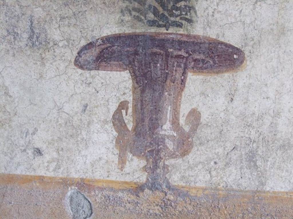 II.1.5 Pompeii.  Large Taberna.  East wall of rear room.   Detail of painting of an urn.