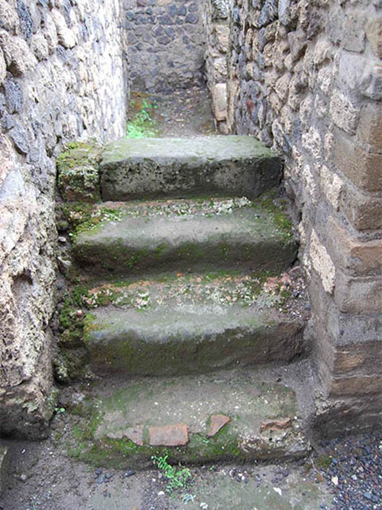 II.2.1 Pompeii. May 2014. Looking west at stairs at rear of bar-room, in south-east corner.
The doorway on the left of the picture would have led into the atrium of II.2.2. Photo courtesy of Paula Lock.
