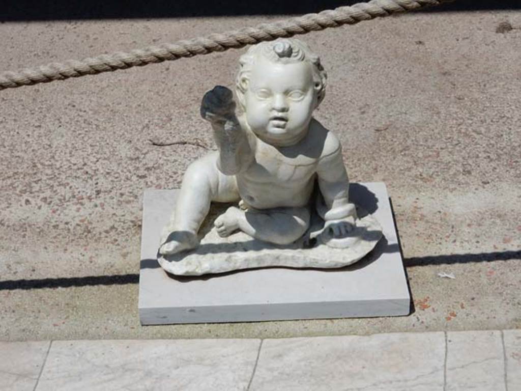 II.2.2 Pompeii. May 2016. Room “i”. White statuette of a young Hercules strangling a snake found on the north side of the upper euripus. Photo courtesy of Buzz Ferebee.  

