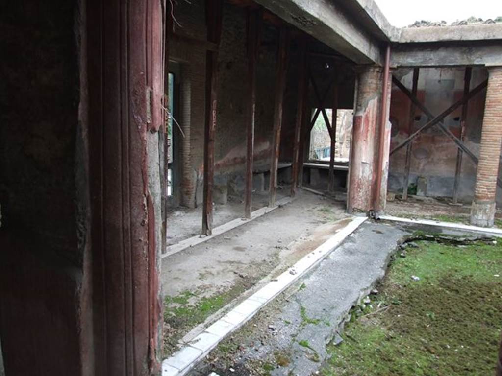 II.4.6 Pompeii. December 2006. View looking east from II.4.5 across the north portico, showing benches for waiting clients.

