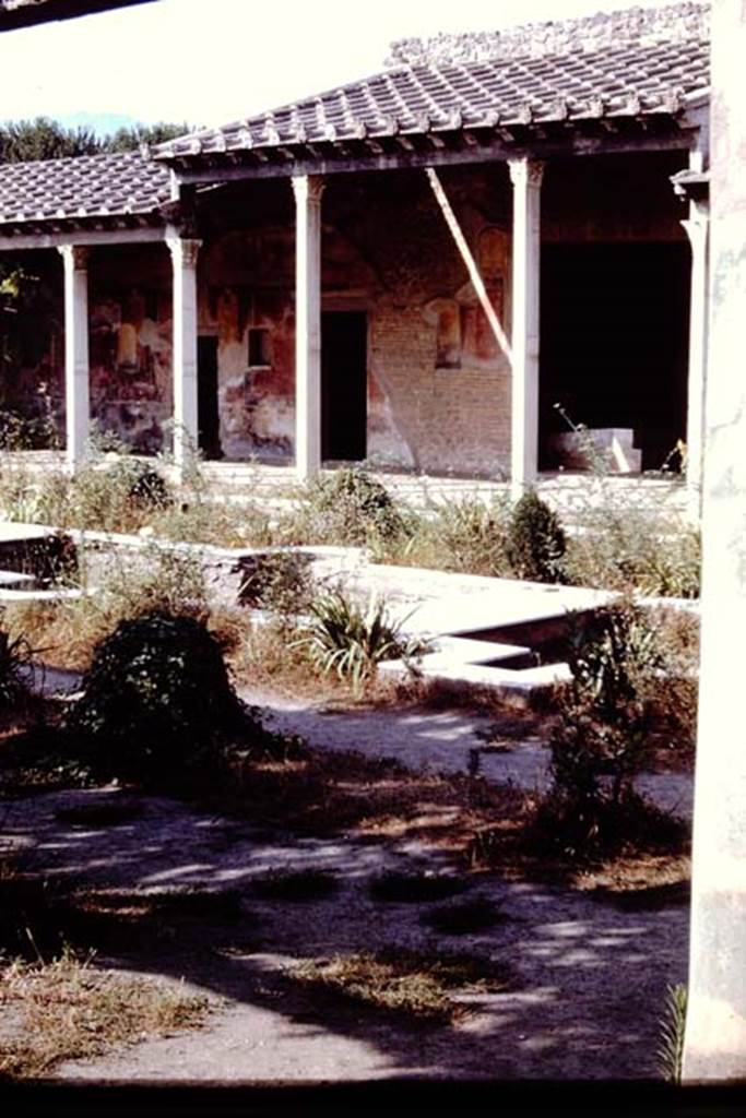 II.4.6 Pompeii. 1966. Looking south-west across garden and water feature towards portico, with doorway to summer triclinium, on right.  Photo by Stanley A. Jashemski.
Source: The Wilhelmina and Stanley A. Jashemski archive in the University of Maryland Library, Special Collections (See collection page) and made available under the Creative Commons Attribution-Non Commercial License v.4. See Licence and use details. J66f0429

