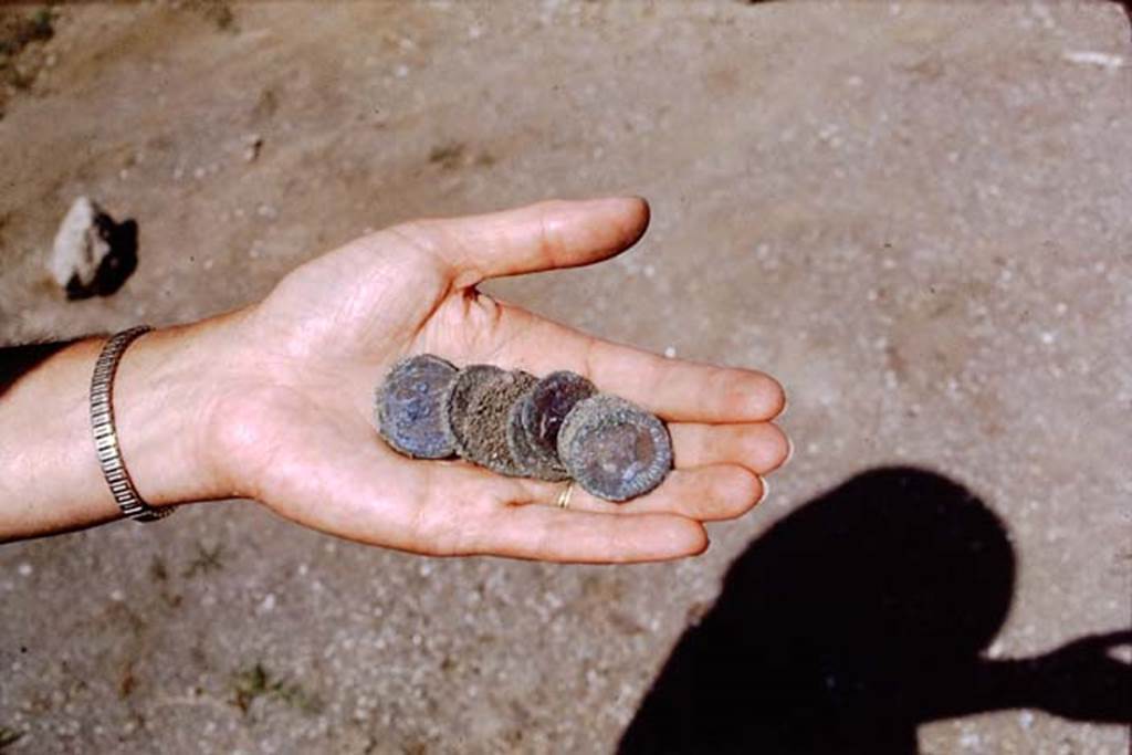 ll.5 Pompeii, 1968.  Coins found near north side of site. Photo by Stanley A. Jashemski.
Source: The Wilhelmina and Stanley A. Jashemski archive in the University of Maryland Library, Special Collections (See collection page) and made available under the Creative Commons Attribution-Non Commercial License v.4. See Licence and use details.
J68f1683
