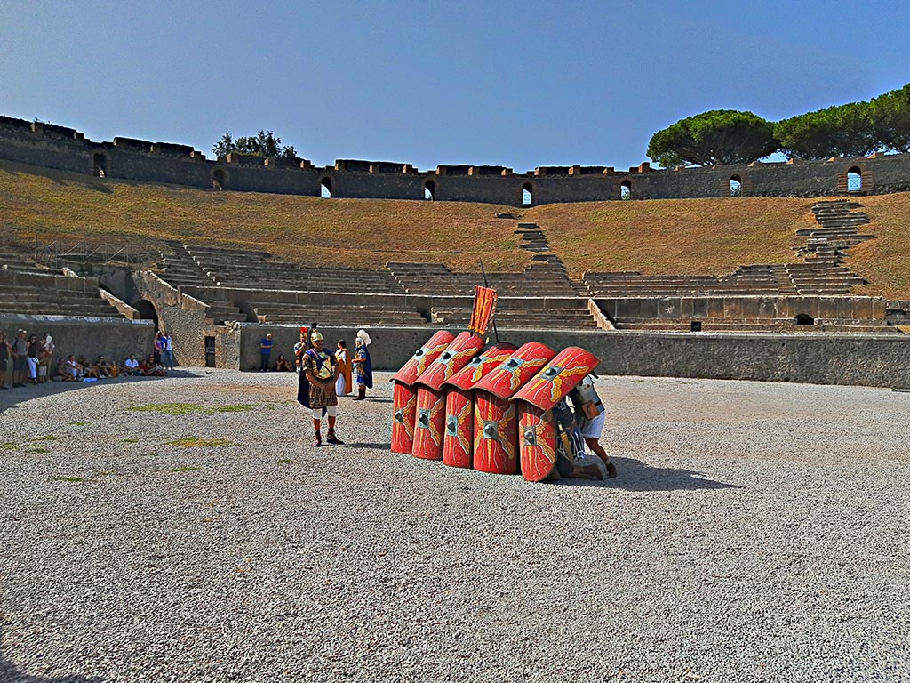 II.6 Pompeii. September 2024. Roman Soldiers – defensive action – forming a side of the Square. 
The hollow square was the formation used to resist/repel cavalry. 
The legionaries would assume a square formation, holding their pila as spears in the space between their shields and strung together shoulder to shoulder. No matter which side the cavalry attacked from, they would be met with a wall of sharp spearheads.
A square formation was also the typical shape of a century in battle.
Photo courtesy of Giuseppe Ciaramella.

