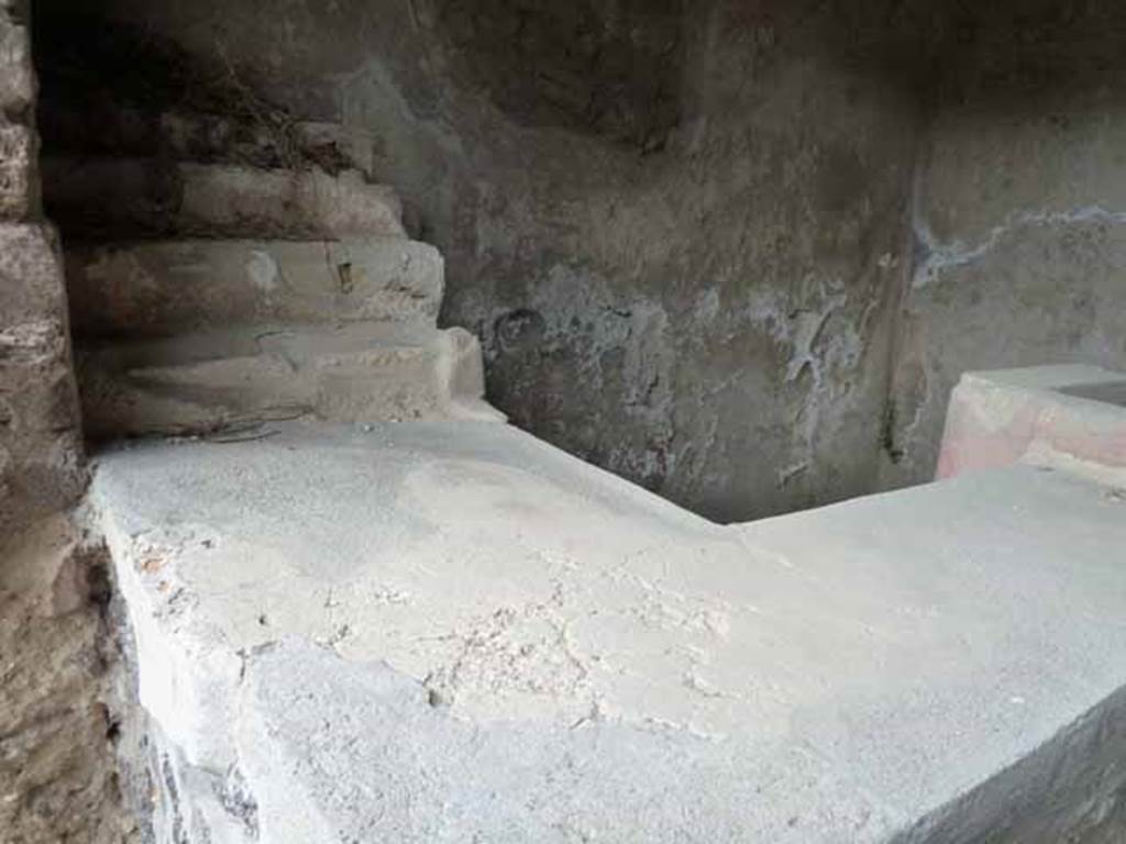 II.8.3 Pompeii. May 2010. Two-sided bar counter, looking north to display shelving.