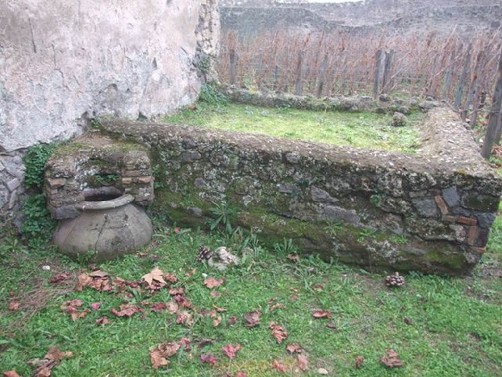 II.9.7 Pompeii. December 2007. Rectangular feature in centre of south wall in garden, probably a raised treading floor where the grapes would have been pressed by foot.
The juice would have flowed into the dolium buried in the soil at the edge of the wall, and then into another dolium found in the peristyle garden inside the house (of II.9.5).
